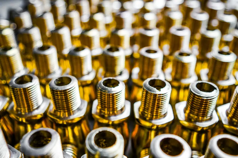 Close-up of rows of brass threaded fittings