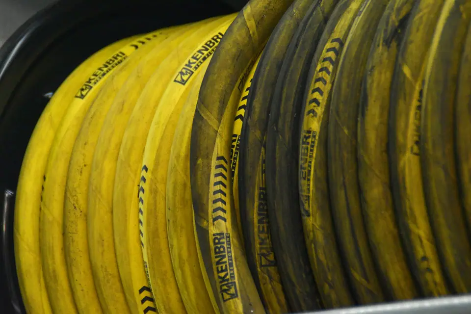 Reels of yellow high-pressure hose