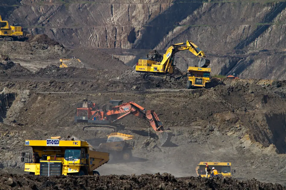 Excavators and haul trucks in an open-pit mine