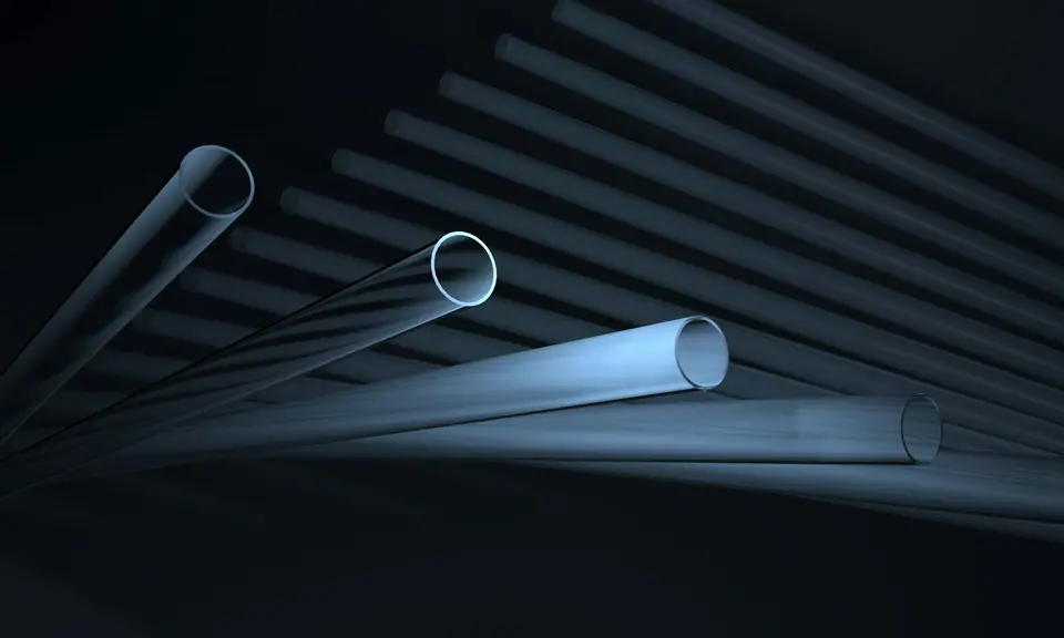 Clear pneumatic tubes lit in blue against a dark background