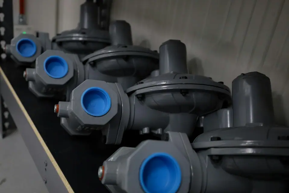 Row of industrial regulators with blue caps